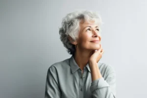 senior-woman-thinking-with-pensive-expression-against-wall-background-ai-generated-scaled